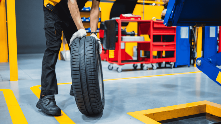 Garage staff learning tyre training by inspecting tread wear bars and understanding tyre wear levels