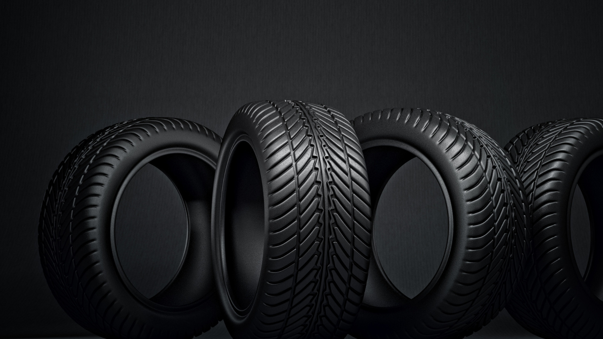 New tyres and worn tyres side by side on a car axle in a tyre shop, showing the importance of replacing tyres in pairs for safety and performance